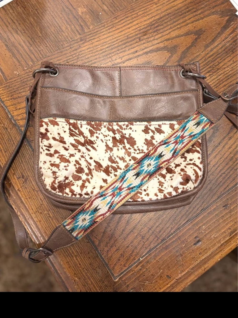 Brown Leather Crossbody Bag with Cowhide Accent and Patterned Strap